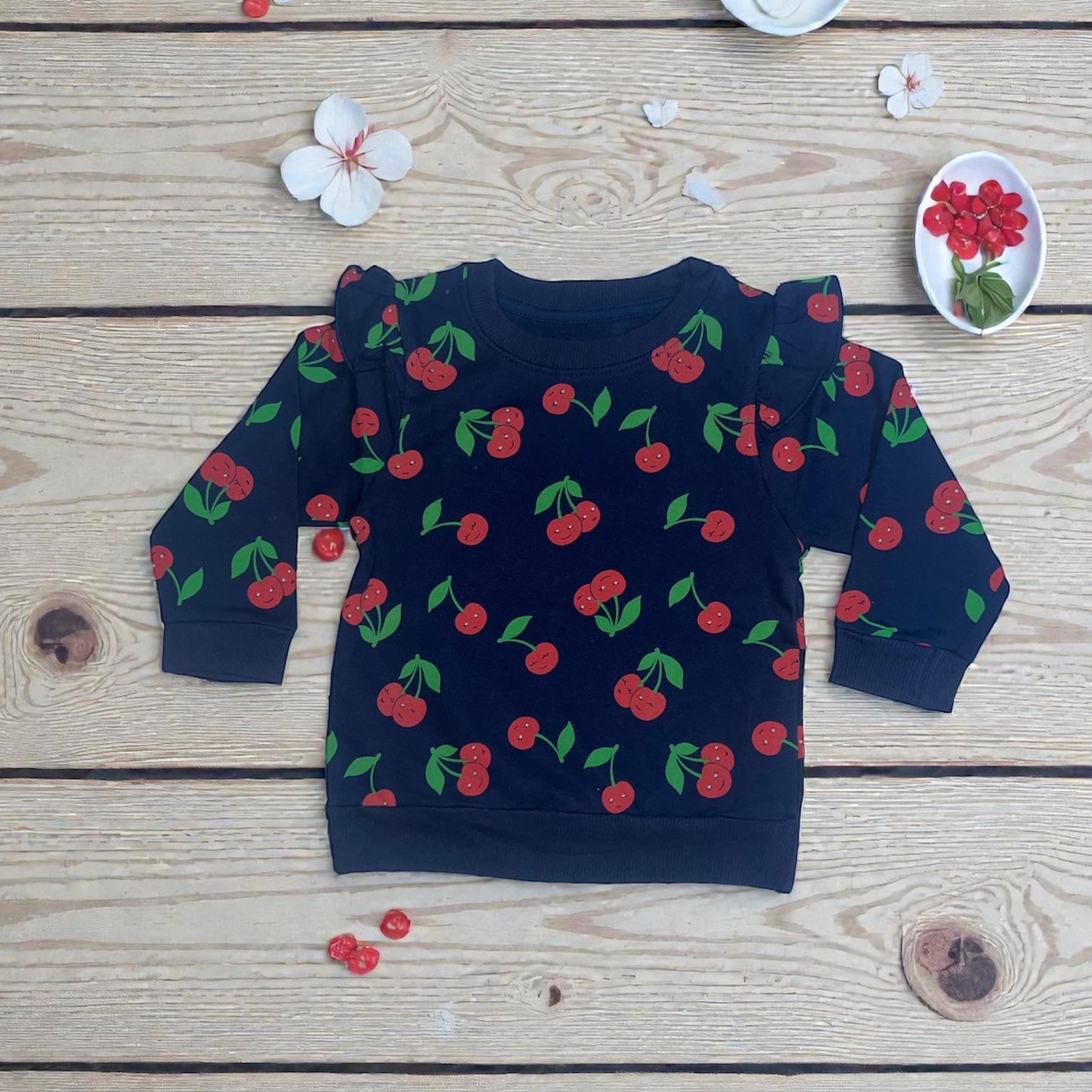 Navy blue children's sweatshirt with red cherry print from Aatiyas Fashion on wooden background