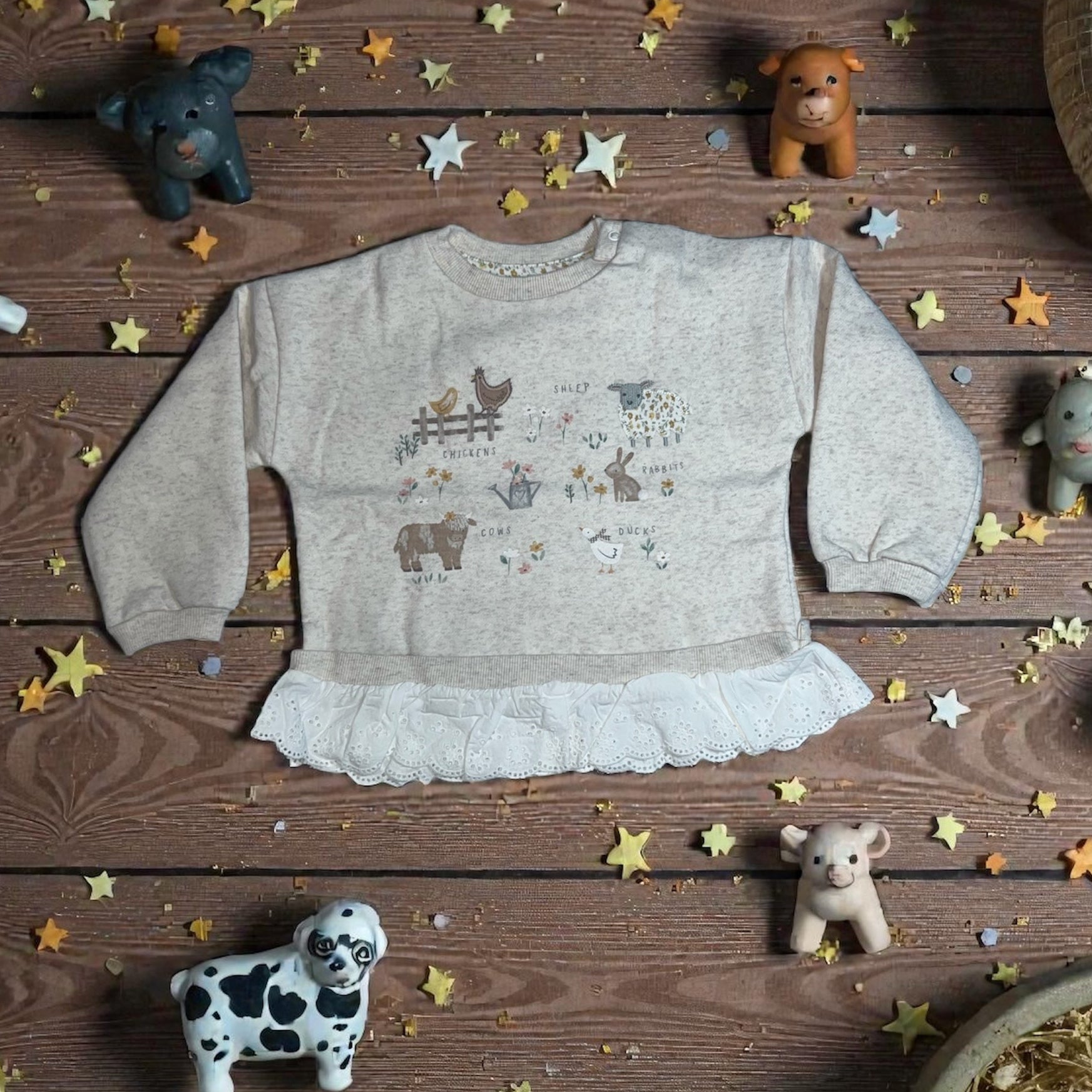 Aatiyas Fashion organic cotton girls' long sleeve top with farm animal print, lace trim, and toy animals on a wooden background.